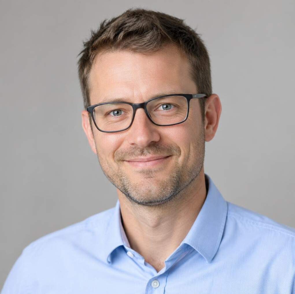 Studio portrait of a man with glasses